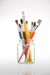 Paint brushes in a jar on whith background