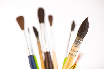 Paint brushes in a jar on whith background