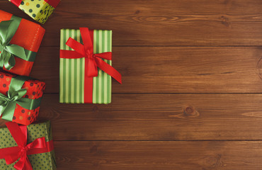 Fototapeta na wymiar Colorful Christmas present boxes on wooden background