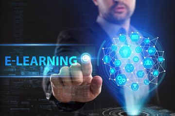The concept of business, technology, the Internet and the network. A young entrepreneur working on a virtual screen of the future and sees the inscription: E-learning