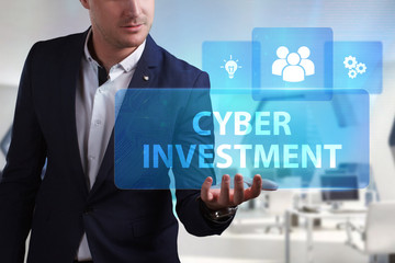 Business, Technology, Internet and network concept. Young businessman working on a virtual screen of the future and sees the inscription: Cyber investment