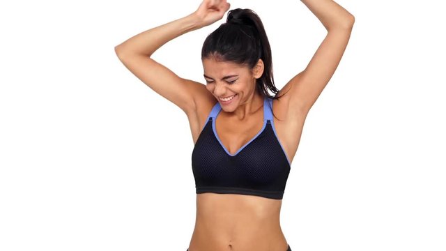 So happy brunette fitness woman rejoice and jumping while looking at the camera over white background