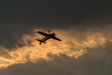 Fototapeta na wymiar Airplane on a sunset sky at an air show