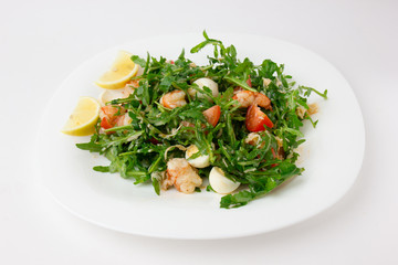 Salad with arugula and shrimp. Fresh dish with arugula, cherry tomatoes, shrimp on a plate.