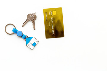 Get a mortgage. Bank card near apartment keys on white background top view copyspace
