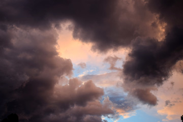 Naklejka na ściany i meble Black clouds in blue sky