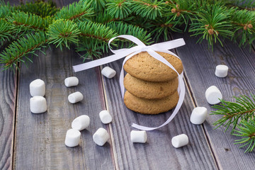 Christmas Gingerbread cookies with decorations and marshmallows on background with christmas tree