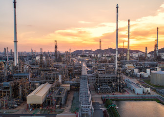 Fototapeta premium Aerial view Oil refinery.Industrial view at oil refinery plant form industry zone with sunrise and cloudy sky.Oil refinery and Petrochemical plant at dusk,Thailand. Oil refinery background sunset.