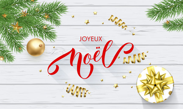 Joyeux Noel French Merry Christmas holiday golden decoration and calligraphy font for greeting card white wooden background. Vector Christmas or New Year golden shiny gift for Xmas decoration design