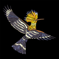 Embroidered bird. Embroidered hoopoe. Vector vintage embroidery in Japanese style  for patches, textiles, fabrics, decor, fashion design and sticker © Oscar Ghost