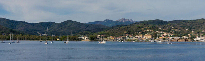 Fototapeta na wymiar Few boats and ships in Elba bay near Italy Tuscany coastline