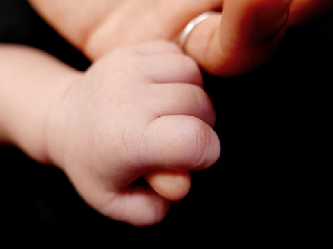 motherhand and babyhand isolated on a black background