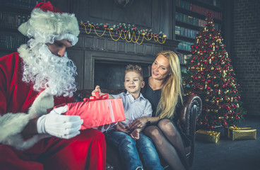 Family home portrait. Parents and son spending time together at christmas time