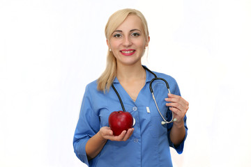 portet of a young girl doctor of a nutritionist with a red apple in hand isolated on white background