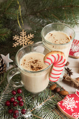 Eggnog, winter Christmas traditional hot drink with milk, eggs, rum. Christmass New Year decoration with gingerbread cookies.