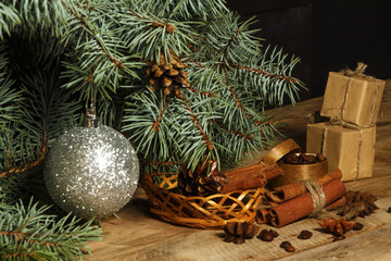 Christmas background decoration with grains of coffee, cinnamon, anise, lemon and spruce branches. 