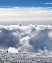 Obraz premium View on ski resort in sun cloudy mountains at evening