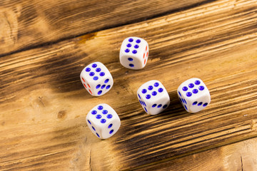 White dice on wooden table. Game of chance concept