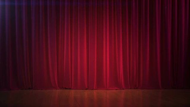 Dark empty stage with rich red curtain.