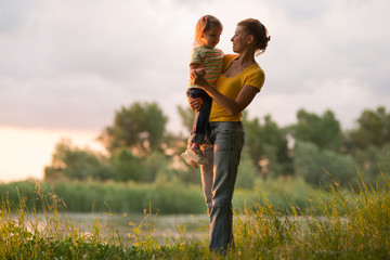 Mom and daughter at sunset