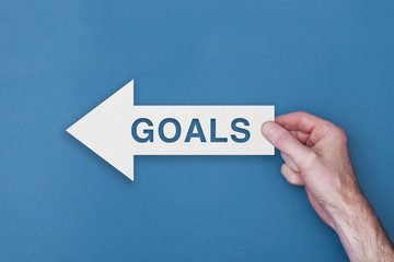 Goals arrow direction held on a blue background