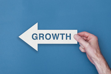 Growth arrow direction held on a blue background