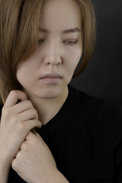 Close up portrait of serious Asian girl.