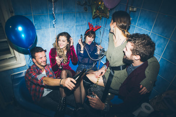 New Year's Party. Birthday party. Group of friends in the bathroom drinking and having fun