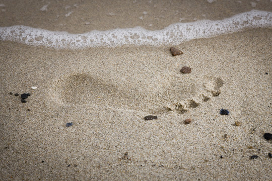 Fußabdruck am Sandstrand