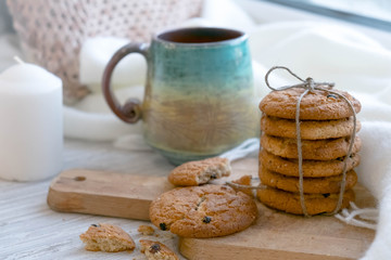cozy winter still life: warm woolen knitting, hot tea, red book, Christmas cookies and music. Headphones. Hygge style. Cozy winter home morning holiday. Soft photo
