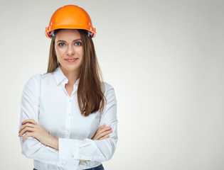 Smiling confident woman builder architect standing with crossed arms.