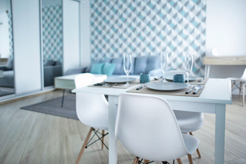 Table served for dinner in light room