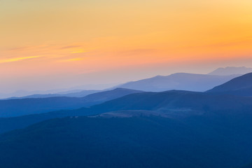 Fototapeta na wymiar Sunset on the peak of mountain 
