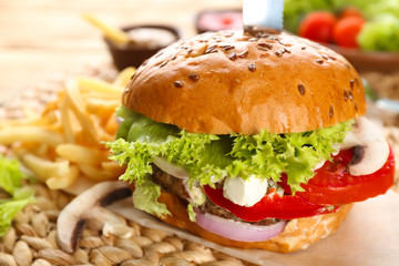 Fresh tasty burger on table