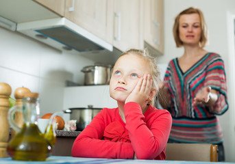 Frustrated mother scolding little kid