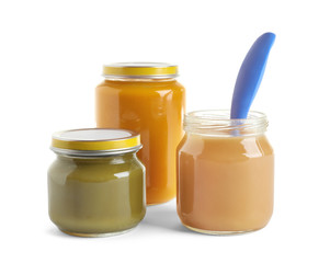 Jars with healthy baby food on white background