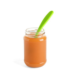 Jar of healthy baby food with spoon on white background