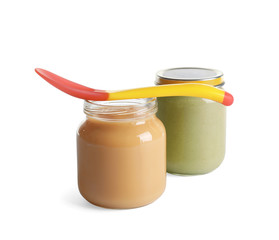 Jars with healthy baby food on white background