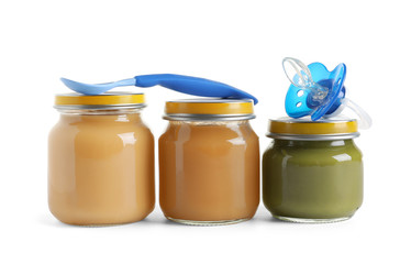 Jars with healthy baby food on white background