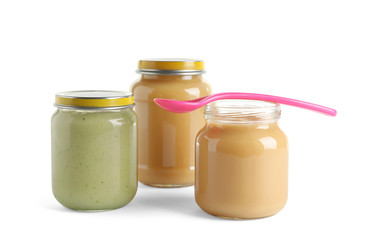 Jars with healthy baby food on white background