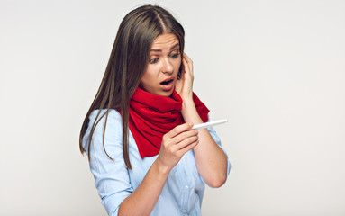 Sick woman looking on thermometer.