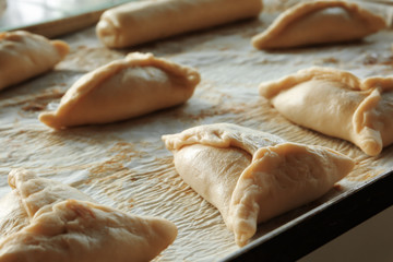 Raw bakery products on baking tray