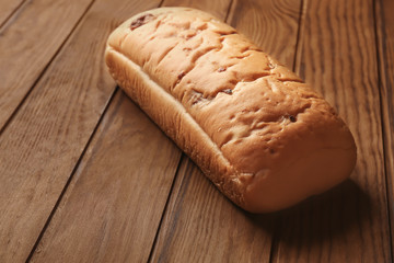 Yummy fresh bread on wooden background