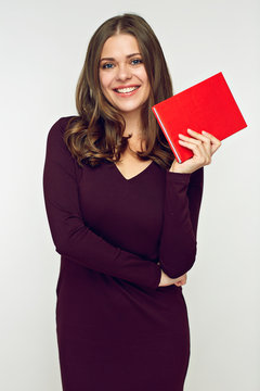 Young woman holding red book.