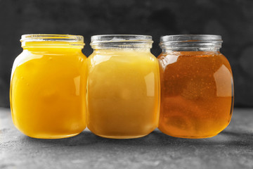 Aromatic honey in jars on table