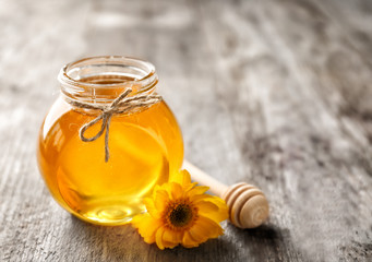 Aromatic honey in jar on table
