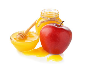 Gravy boat and jar with aromatic honey and apple on white background