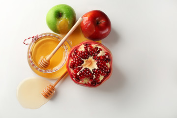 Composition with aromatic honey and fruits on white background