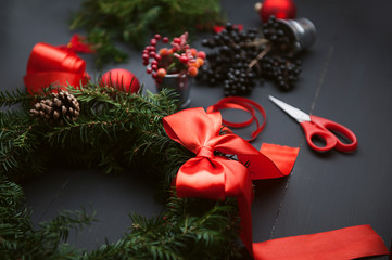 mom makes a Christmas wreath with her own hands
