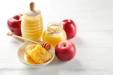Composition with honey and fruit on wooden background